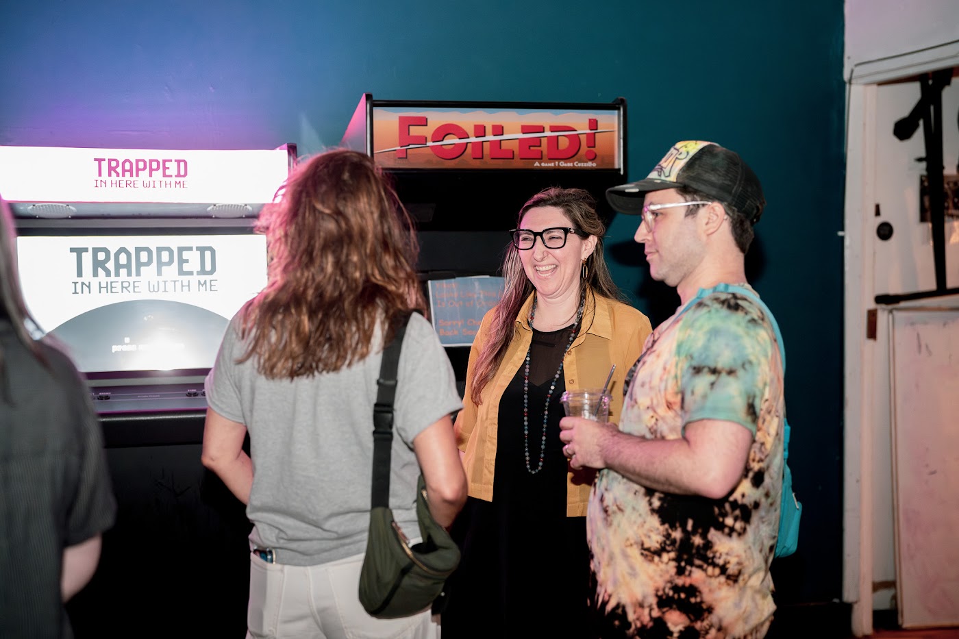 Three organizers laughing together at the May meetup