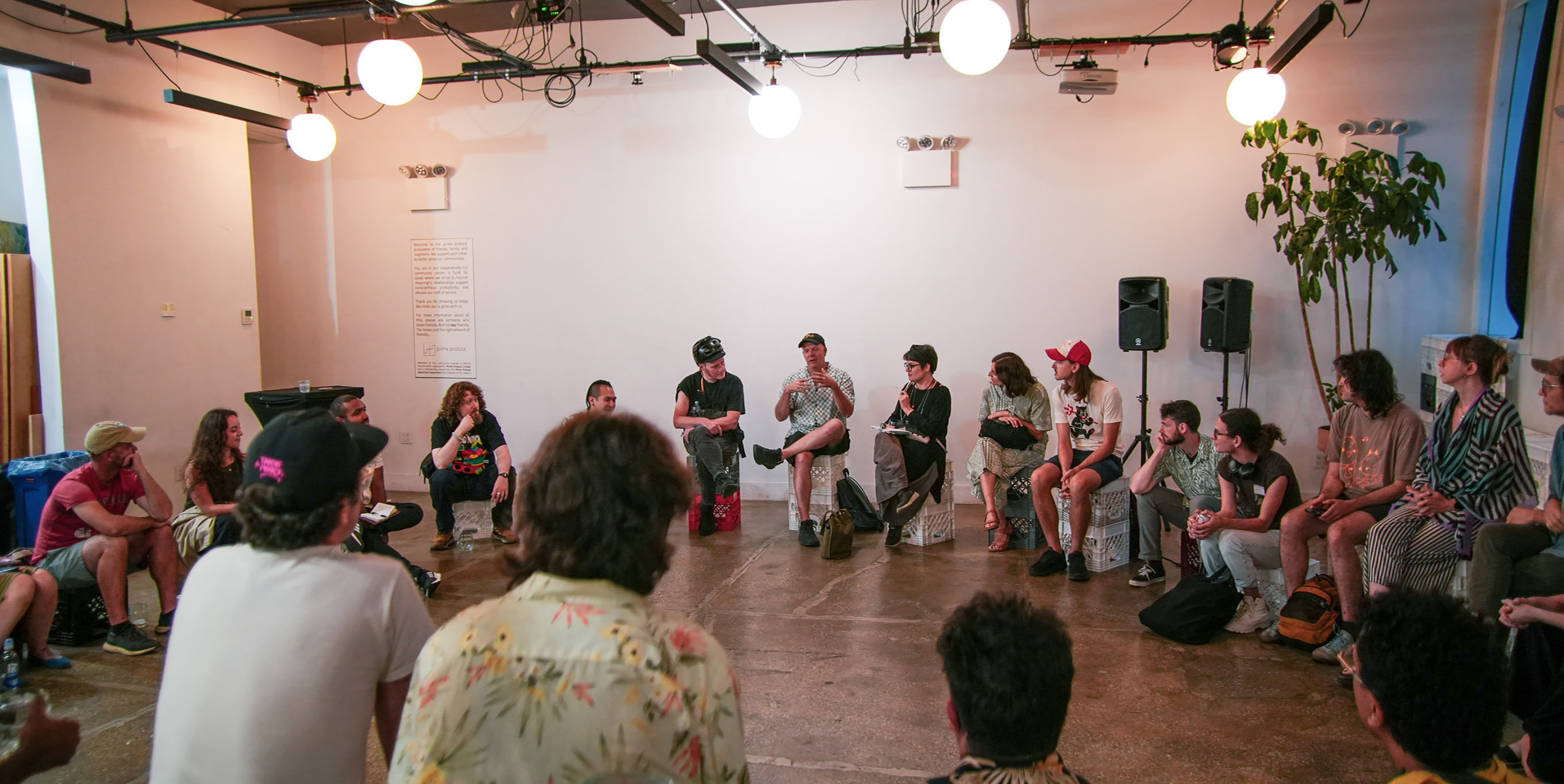 Event organizers gathered in a large circle at the August meetup at Prime Produce